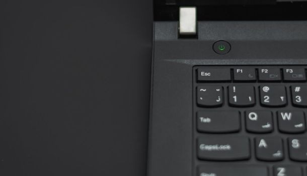 Close-up view of a black laptop keyboard, showcasing the keys and their layout in detail.