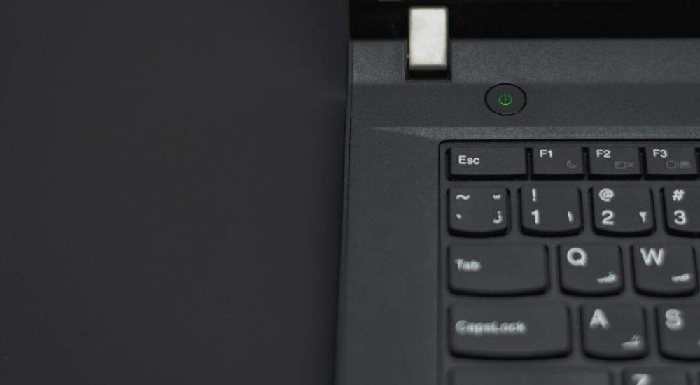 Close-up view of a black laptop keyboard, showcasing the keys and their layout in detail.